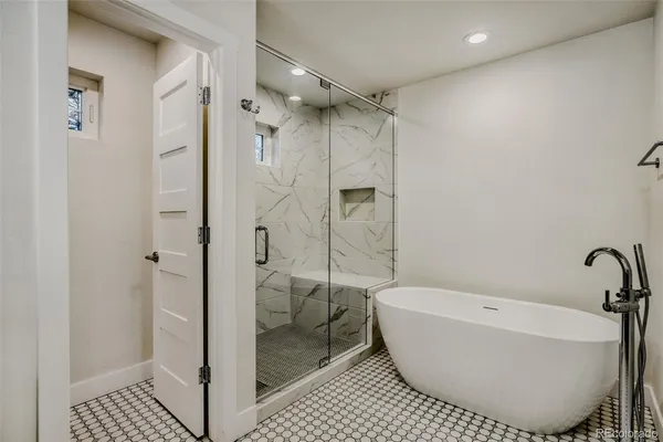 a bathroom with a bathtub and shower