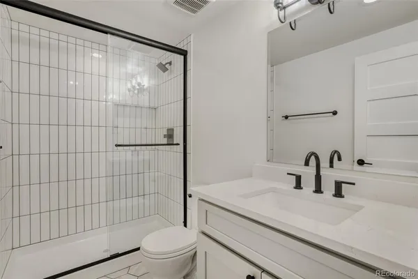 a bathroom with a sink toilet and shower