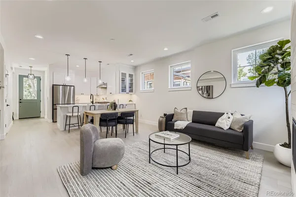 a living room with furniture and a clock