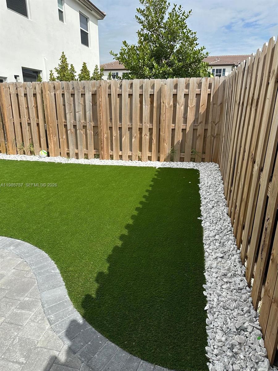 12221 Northwest 23rd Place Miami, FL 33167 - Photo 11 of 17 a view of a yard with wooden fence