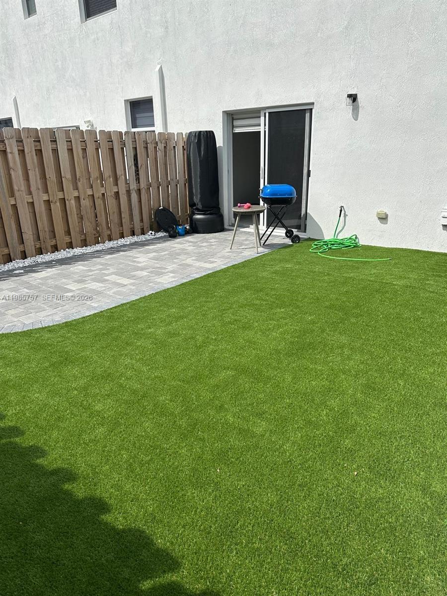 12221 Northwest 23rd Place Miami, FL 33167 - Photo 12 of 17 a view of a backyard with wooden fence and a bench