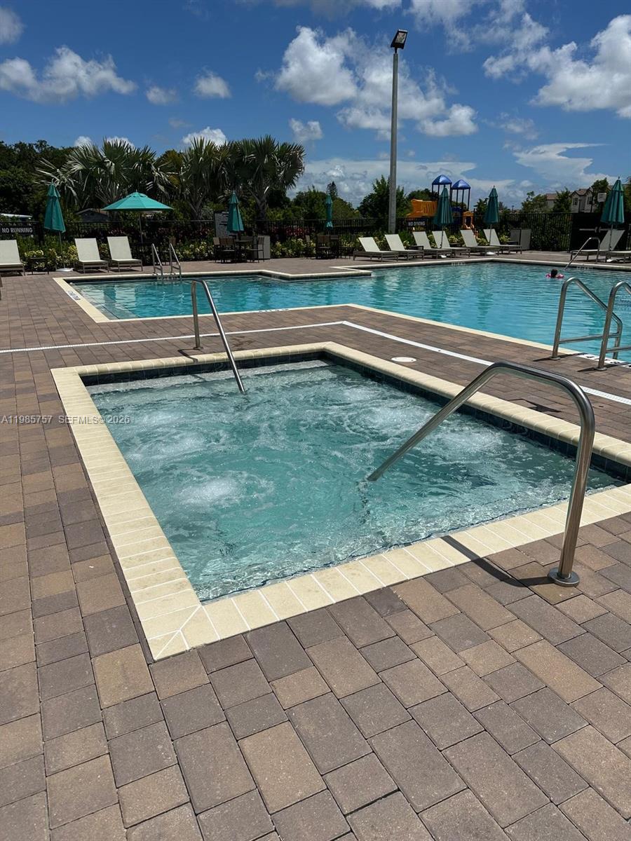 12221 Northwest 23rd Place Miami, FL 33167 - Photo 13 of 17 a view of swimming pool with outdoor seating and yard in the back
