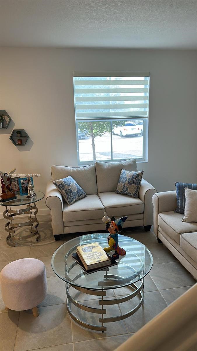 12221 Northwest 23rd Place Miami, FL 33167 - Photo 2 of 17 a living room with furniture and a large window