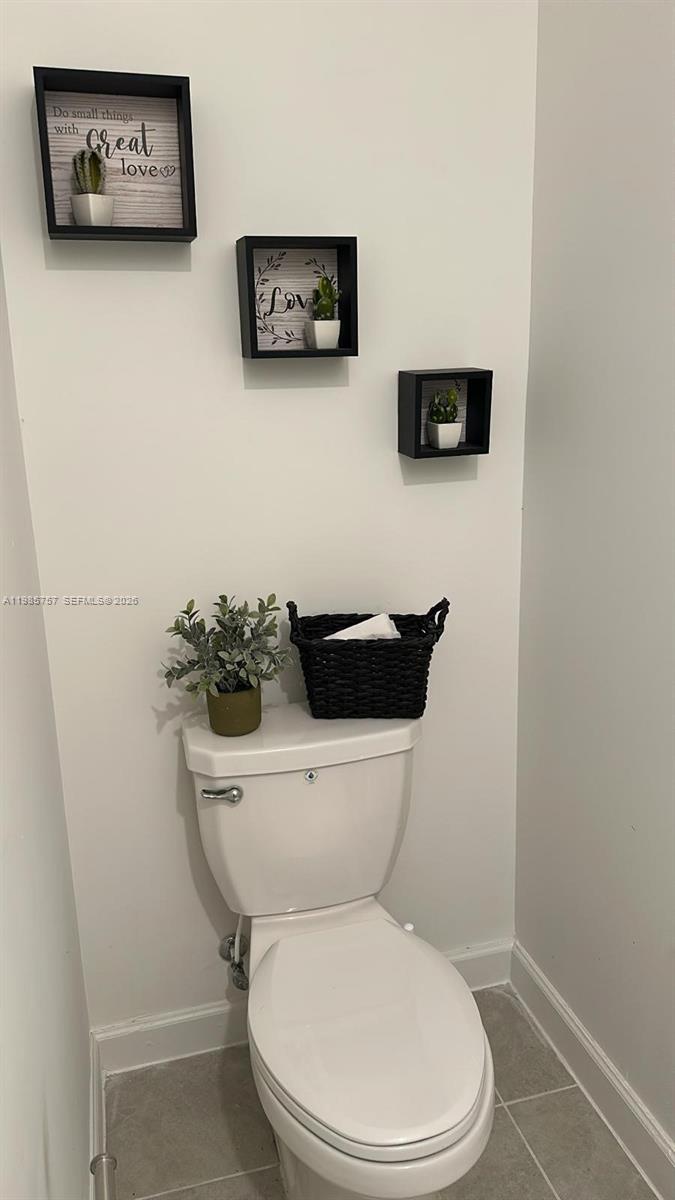 12221 Northwest 23rd Place Miami, FL 33167 - Photo 7 of 17 a white toilet sitting next to a white wall