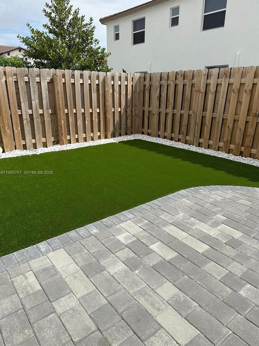 12221 Northwest 23rd Place Miami, FL 33167 - Photo 10 of 17 a view of backyard with wooden fence