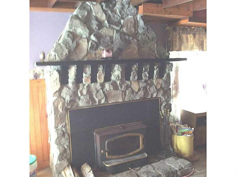 69 West Shore Road Sebago, ME 04029 - Photo 9 of 12 Living Room. Great New England stone...