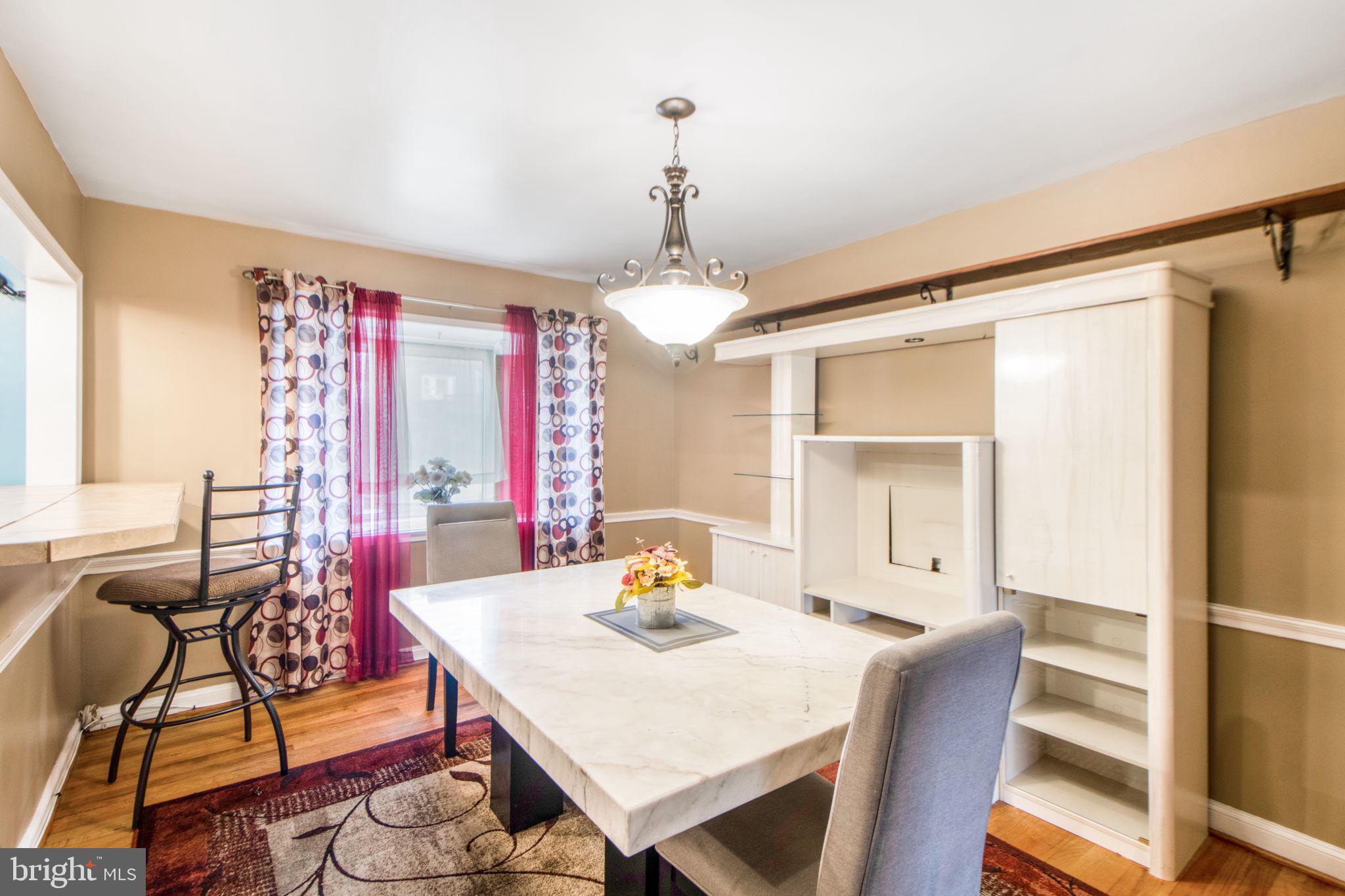 1903 Heathfield Road Baltimore, MD 21239 - Photo 8 of 30 a view of a dining room with furniture window and wooden floor