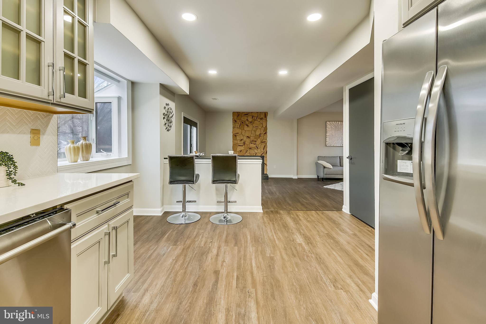4238 Briars Road Olney, MD 20832 - Photo 11 of 44 a kitchen with stainless steel appliances a refrigerator and wooden floor