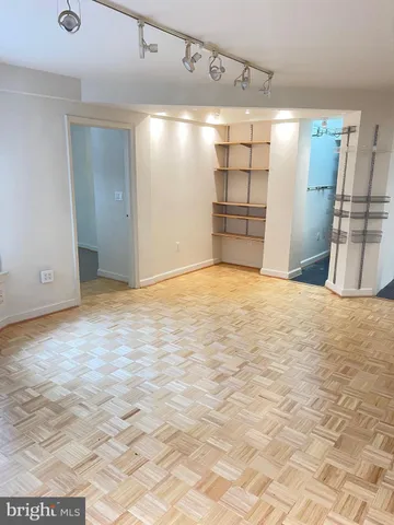 a view of an empty room with glass door