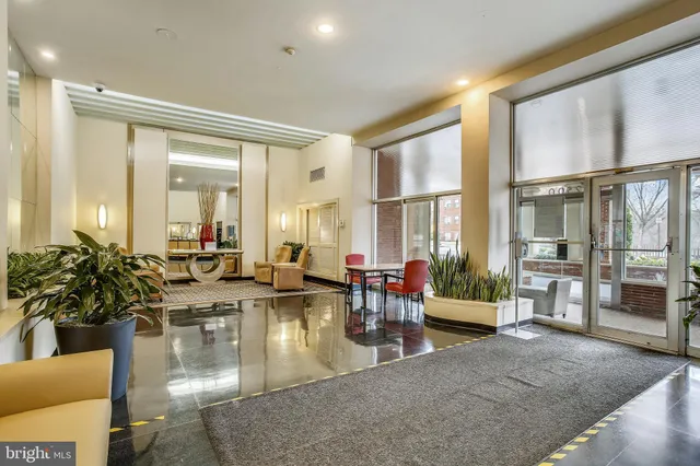 a living room with fireplace furniture and large windows
