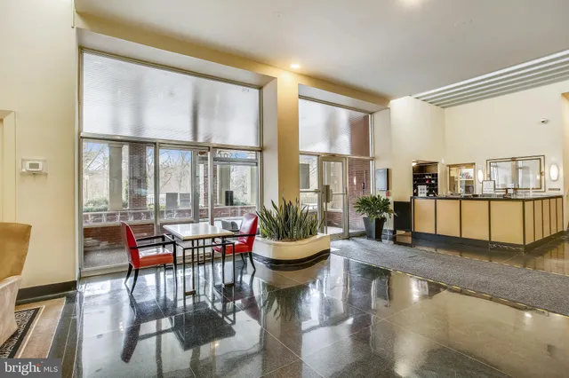 a living room with furniture and floor to ceiling windows