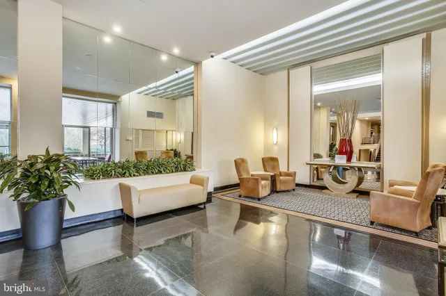 a living room with furniture and flowers