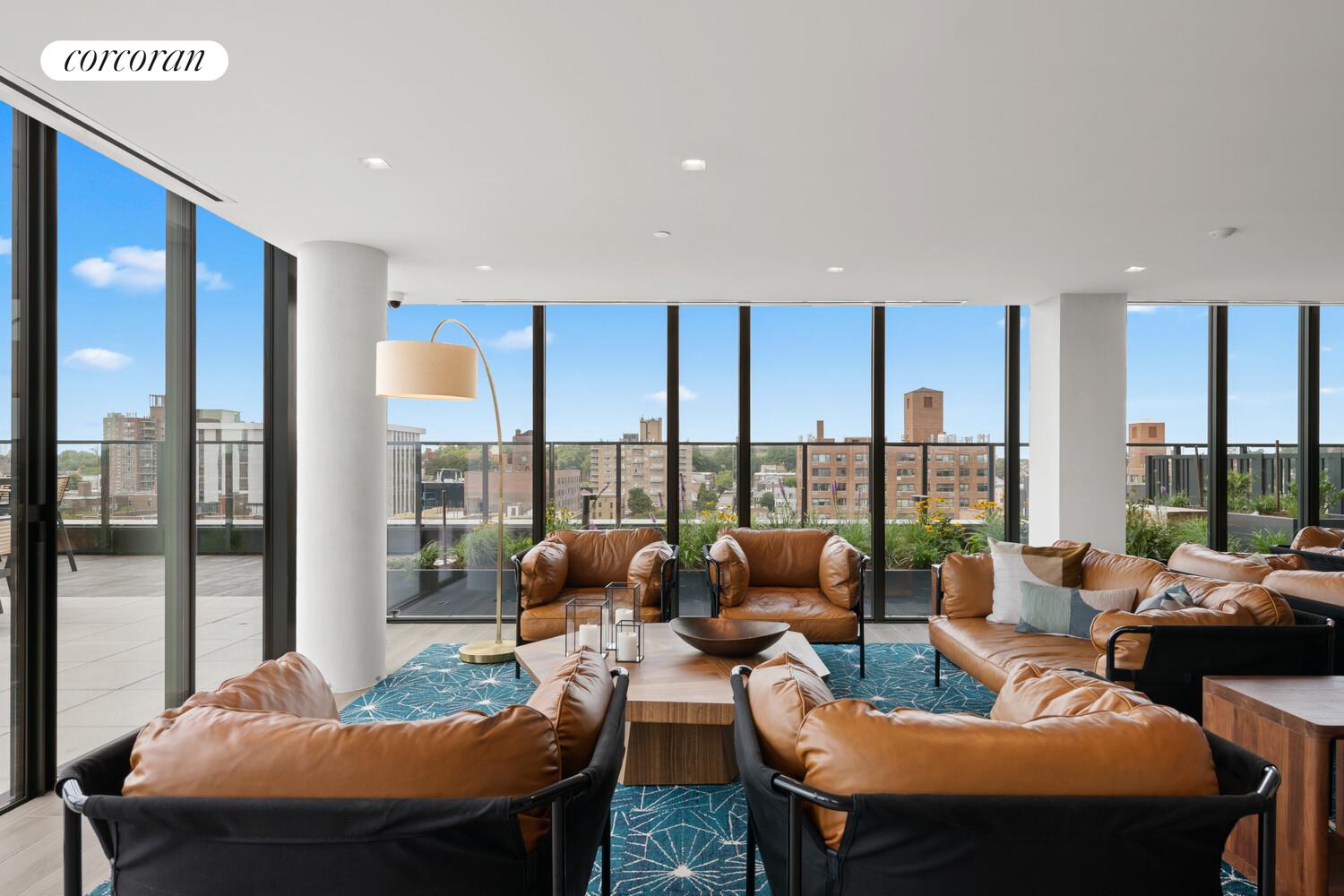166-20 90th Avenue, Unit 437 Queens, NY 11432 - Photo 14 of 15 a living room with furniture and a large window