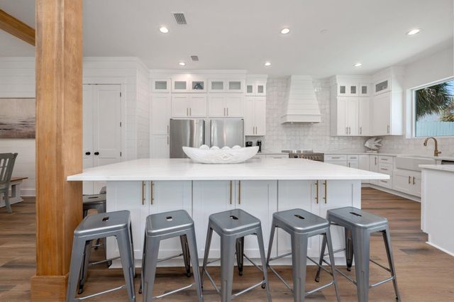 a kitchen with stainless steel appliances a refrigerator and a stove top oven