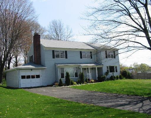 a view of house with a yard