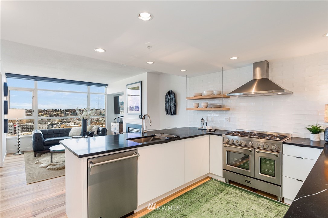 1420 Terry Avenue, Unit 2602 Seattle, WA 98101 - Photo 14 of 40 a kitchen with a stove a sink and a refrigerator