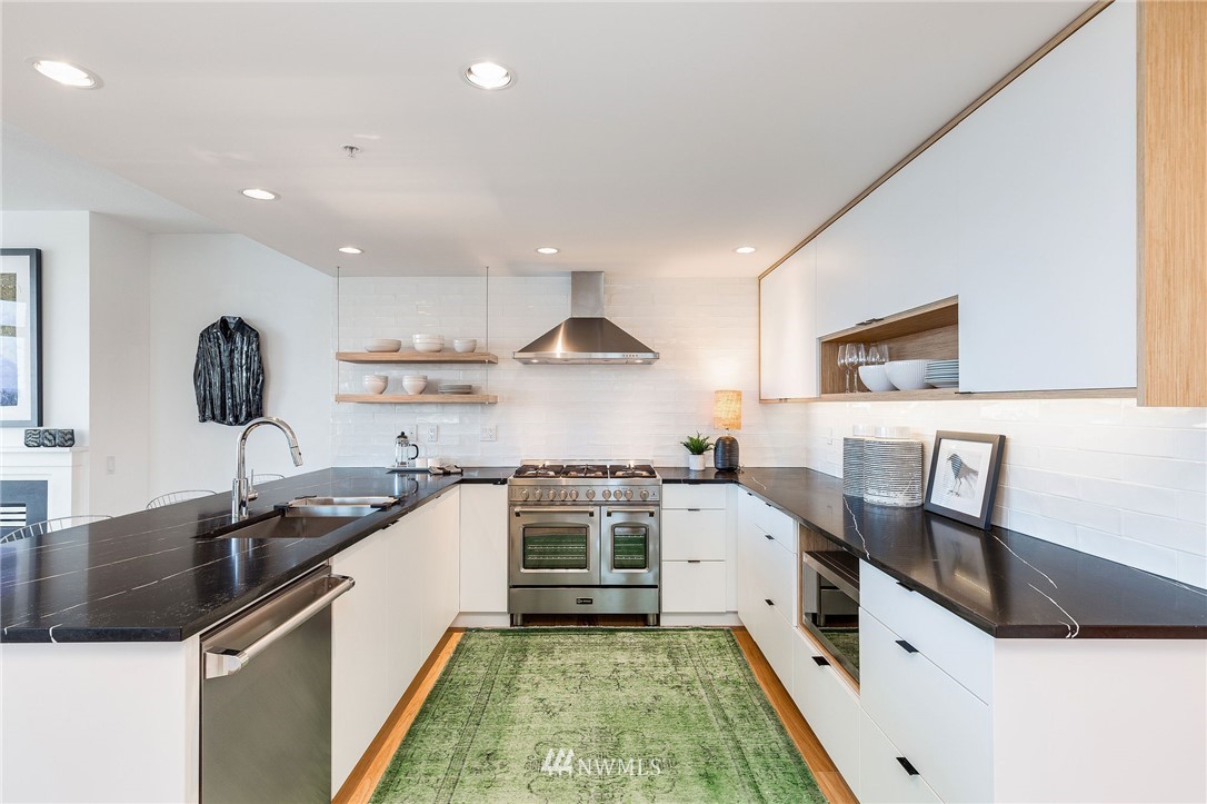 1420 Terry Avenue, Unit 2602 Seattle, WA 98101 - Photo 15 of 40 a kitchen with a sink stove and cabinets