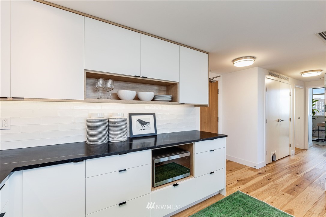 1420 Terry Avenue, Unit 2602 Seattle, WA 98101 - Photo 17 of 40 a kitchen with white cabinets and white appliances
