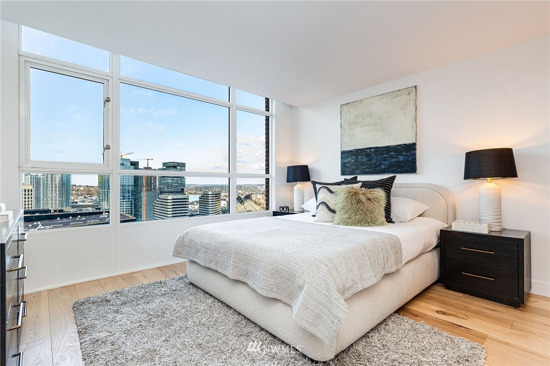 1420 Terry Avenue, Unit 2602 Seattle, WA 98101 - Photo 20 of 40 a bedroom with a large bed and a night stand