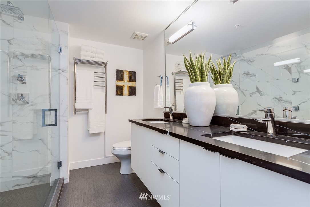 1420 Terry Avenue, Unit 2602 Seattle, WA 98101 - Photo 24 of 40 a spacious bathroom with a granite countertop sink and a mirror