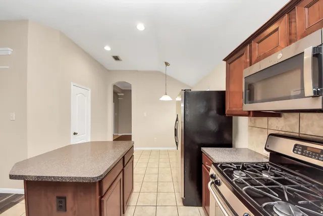 a kitchen with a stove and a refrigerator