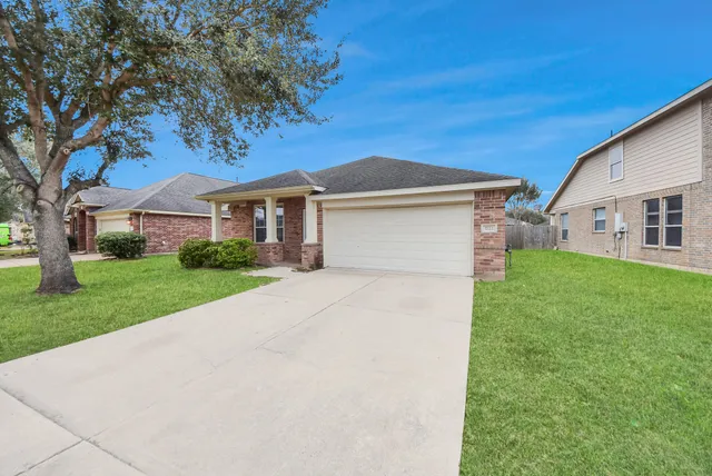an aerial view of a house with a yard and fountain in front of it