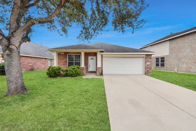 a spacious bathroom with a granite countertop sink a mirror and a bathtub
