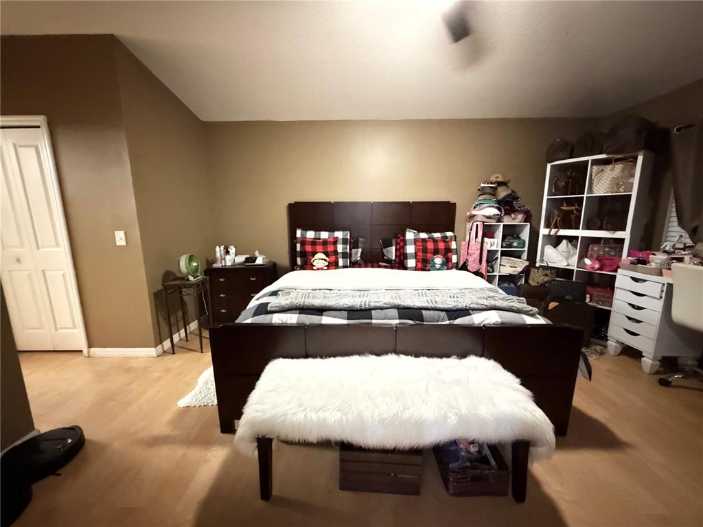 945 Tramells Trail Kissimmee, FL 34744 - Photo 21 of 36 a bedroom with a bed and a flat tv screen on dresser