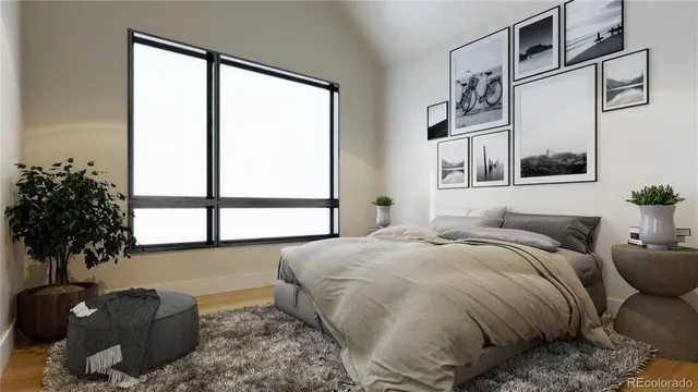 a bedroom with a bed and a potted plant next to a window