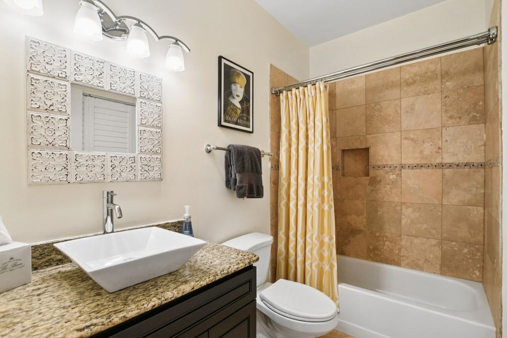 2921 Lenox Road Northeast, Unit 103 Atlanta, GA 30324 - Photo 28 of 37 a bathroom with a granite countertop sink toilet and shower