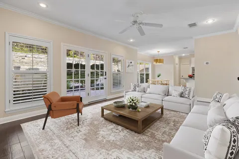 a living room with furniture and floor to ceiling windows