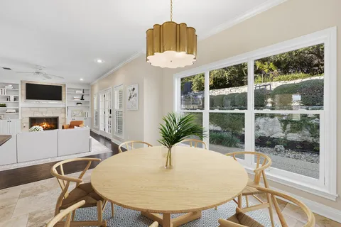 a view of a dining room with furniture window and outside view