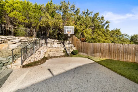 a view of a yard with wooden fence