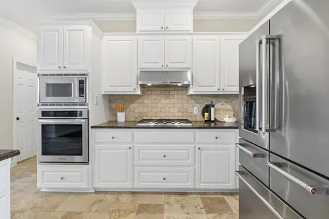a kitchen with a stove top oven sink and cabinets