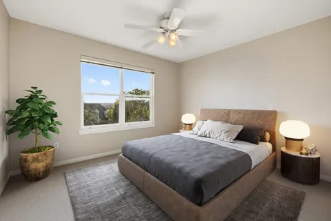 a bedroom with furniture and a large window