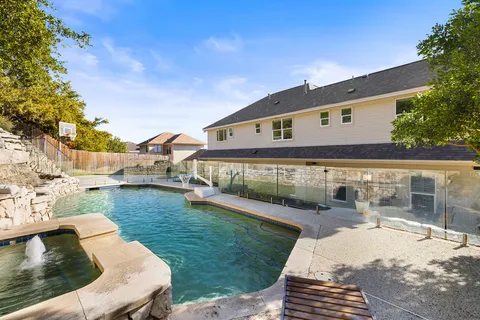 a view of a house with backyard and sitting area
