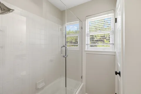 a bedroom with a bed and a large window