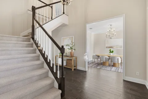a view of entryway and hall with wooden floor