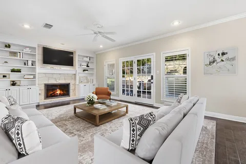a living room with furniture a flat screen tv and a fireplace