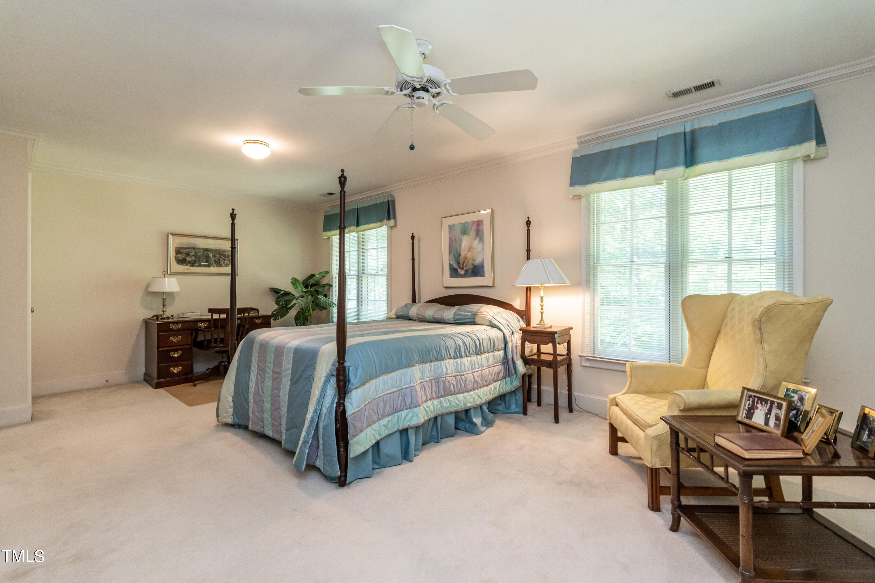 3341 Ridgecrest Court Raleigh, NC 27607 - Photo 16 of 26 a spacious bedroom with a bed a table and chair