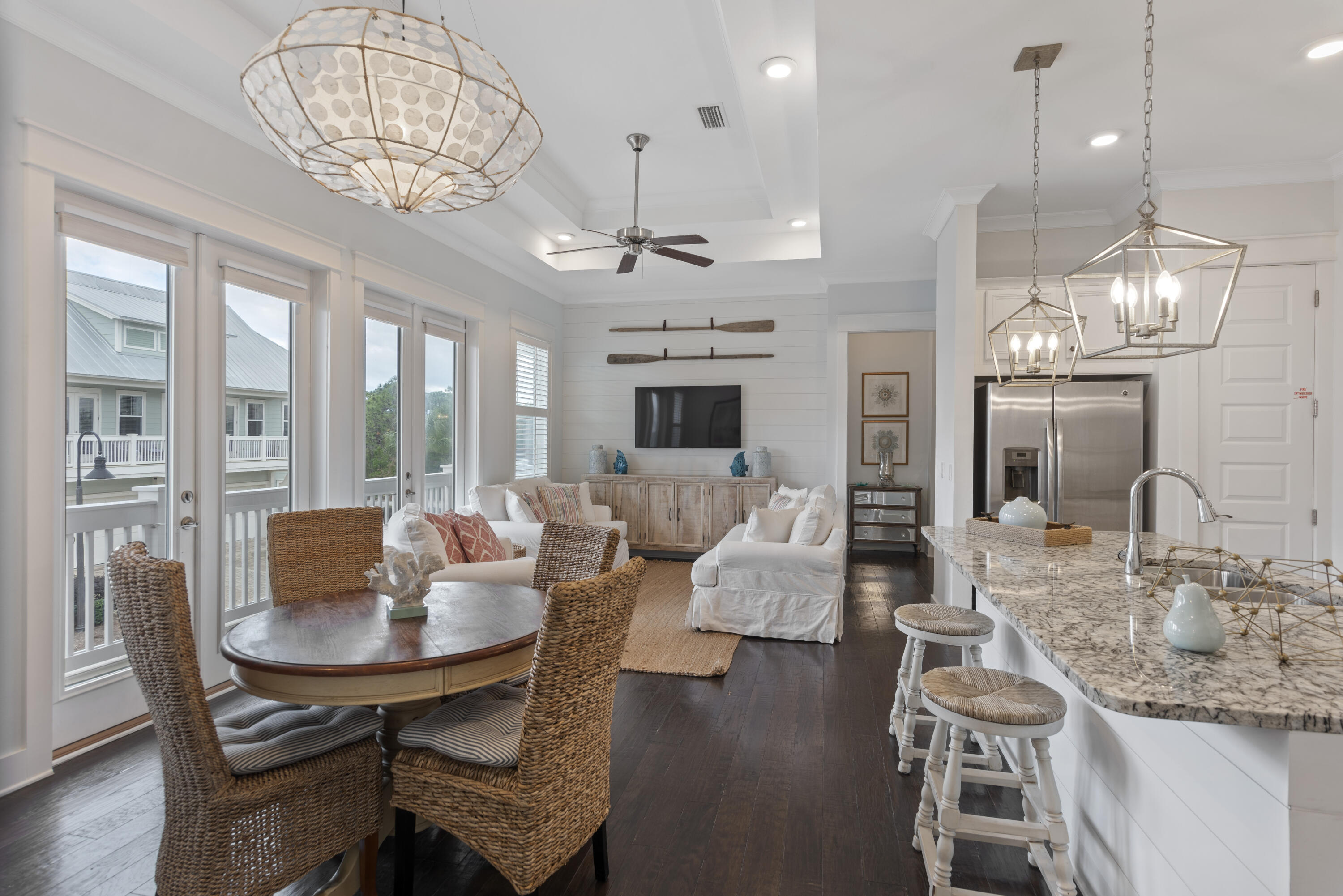 94 York Ln Inlet Beach, Unit C Inlet Beach, FL 32461 - Photo 8 of 36 a view of a dining room with furniture a chandelier and wooden floor