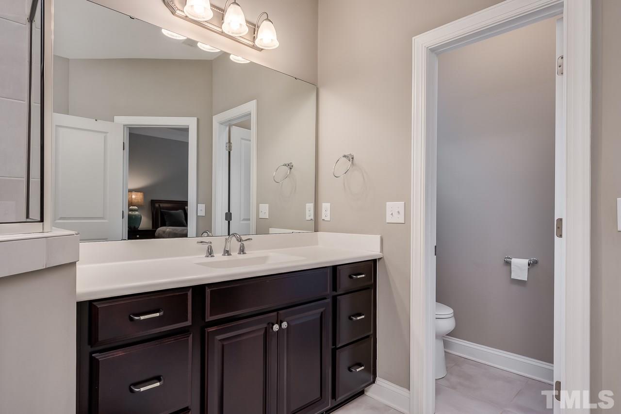 3608 Julia Lane Raleigh, NC 27609 - Photo 13 of 30 a bathroom with a sink a toilet and a mirror