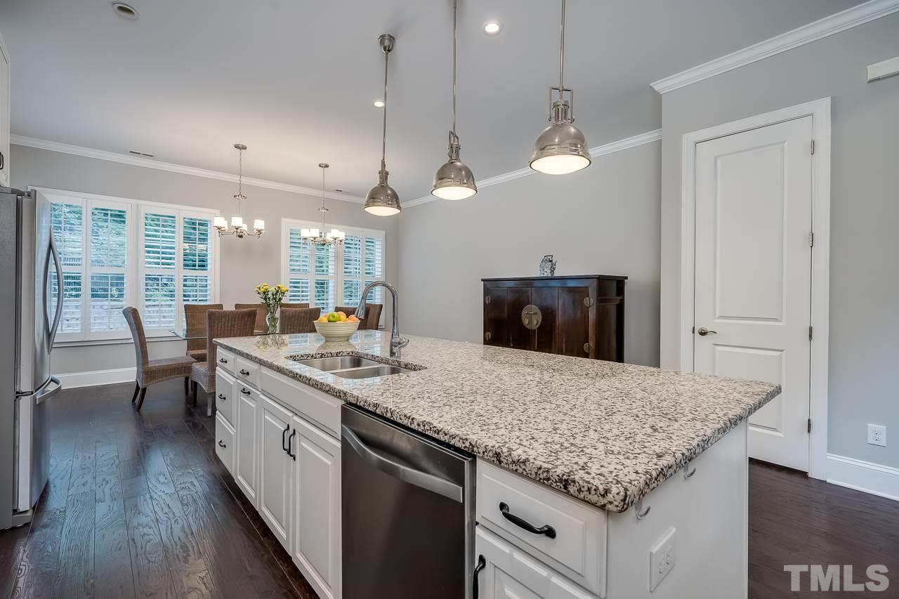 3608 Julia Lane Raleigh, NC 27609 - Photo 3 of 30 a kitchen with center island and living room