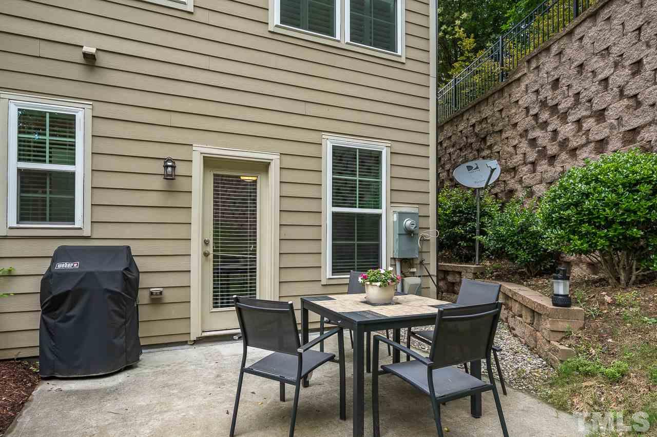 3608 Julia Lane Raleigh, NC 27609 - Photo 27 of 30 a view of a patio with table and chairs and potted plants
