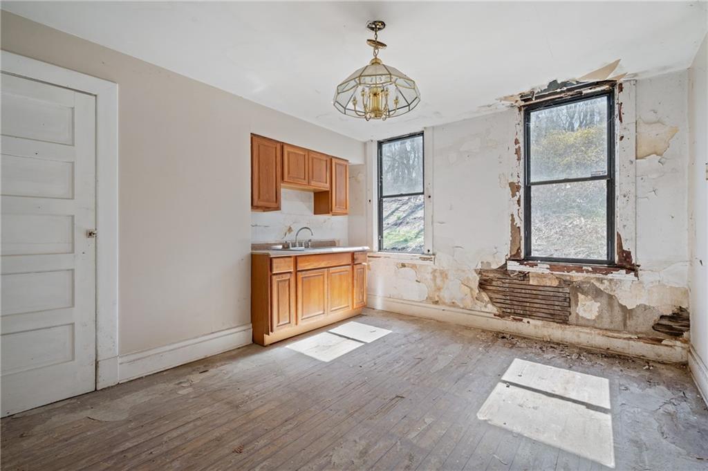 1339 Romanhoff Street Pittsburgh, PA 15212 - Photo 15 of 30 a kitchen with stainless steel appliances granite countertop a stove a sink and a microwave