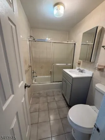a bathroom with a sink a toilet a mirror and shower