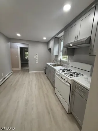 a kitchen with granite countertop a stove and a sink