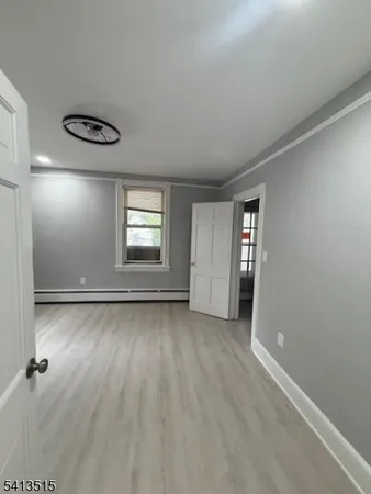 an empty room with windows and closet