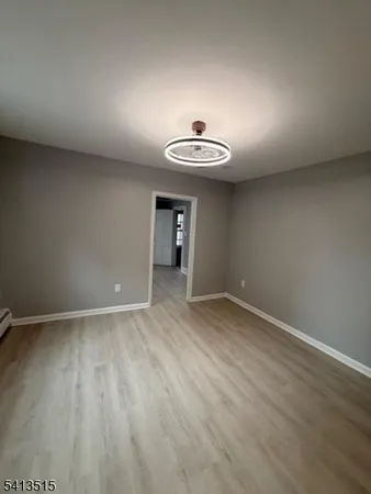 a view of a room with wooden floor and sink
