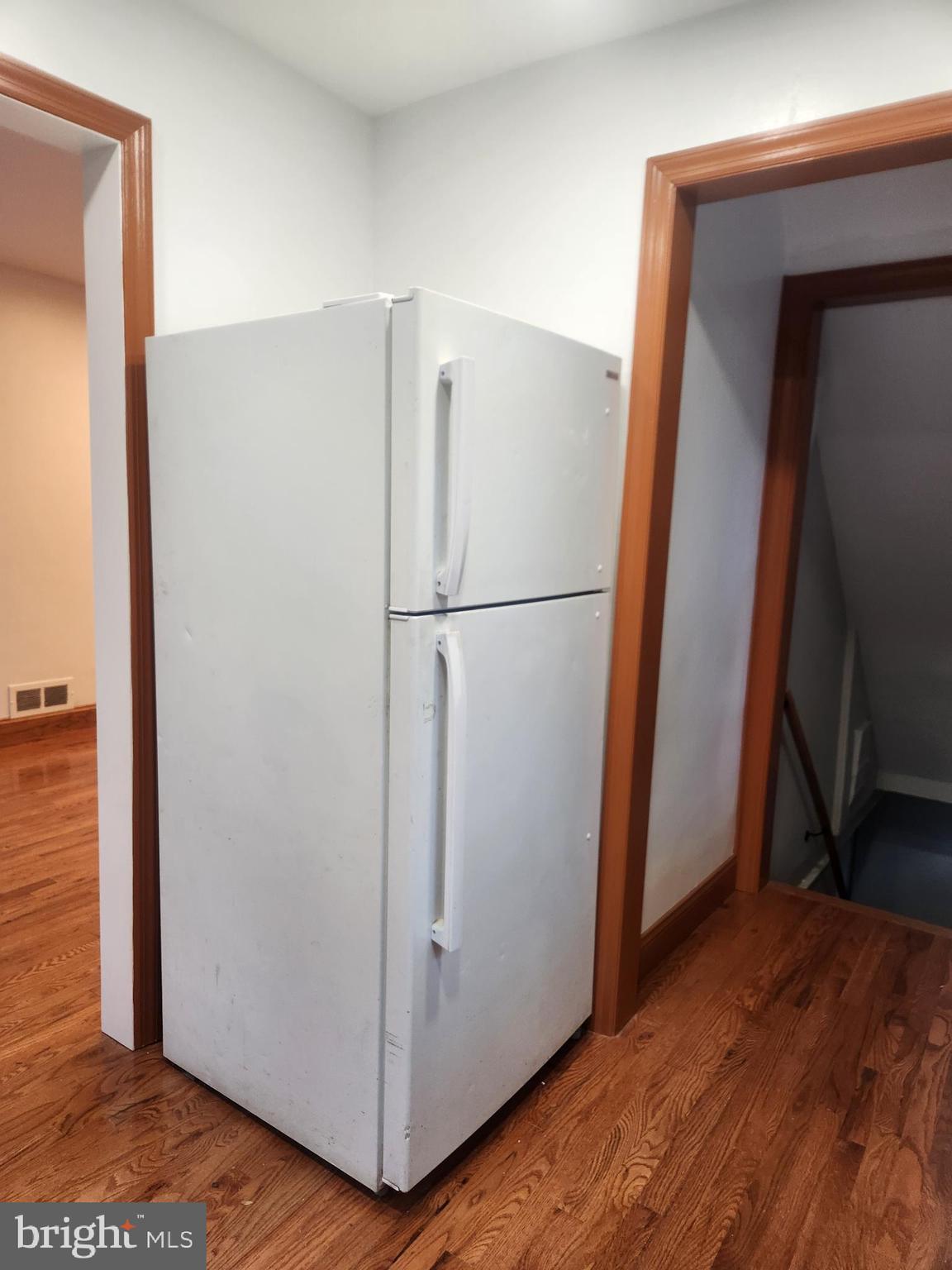 502 East Schuyler Road Silver Spring, MD 20901 - Photo 14 of 38 a view of a refrigerator in kitchen and an empty room